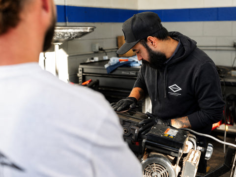 Advanced Air & Vacuum Automotive Division technician servicing shop equipment for professional vehicle repair facilities.