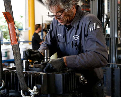 Advanced Air & Vacuum technician fixing an industrial vacuum pump at our shop in San Diego which serves all of Southern California and Arizona.