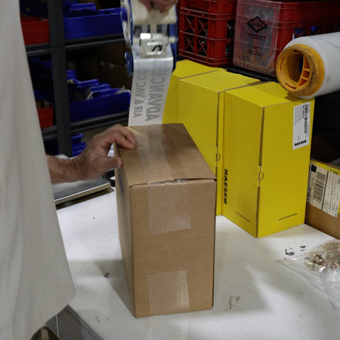 Air compressor parts order being packed for pickup or shipping from Advanced Air & Vacuum in Avondale, AZ.