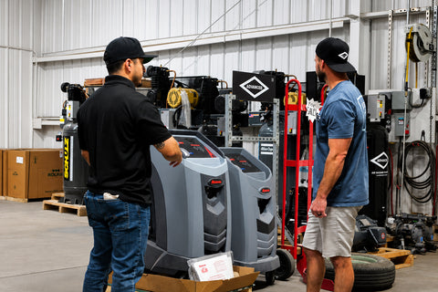 Advanced Air & Vacuum team reviewing automotive shop equipment, vehicle lifts, compressors, and service equipment for Southern California repair facilities.
