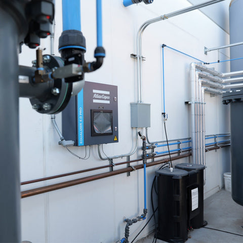 Compressed air dryer and treatment system with filtration, tanks, and condensate management installed for clean dry air in industrial facility