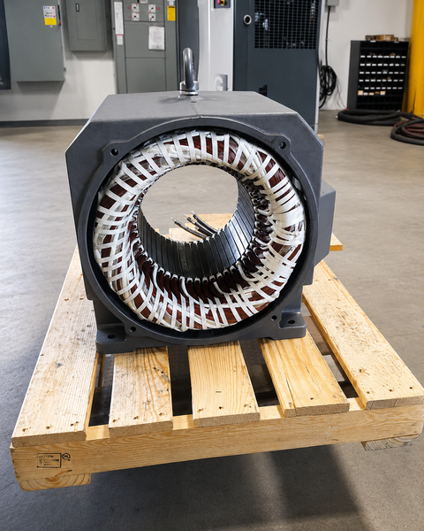Electric motor stator repair and rewinding work staged on a pallet inside the Advanced Air & Vacuum motor shop.