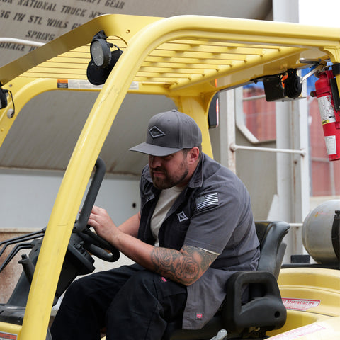 Forklift transporting industrial air compressor equipment during installation process