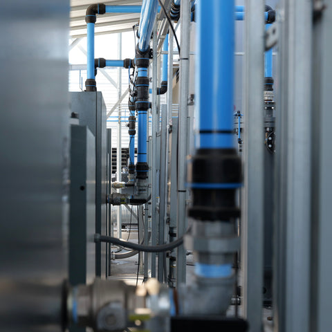 Installed compressed air piping system with blue aluminum air lines in industrial facility